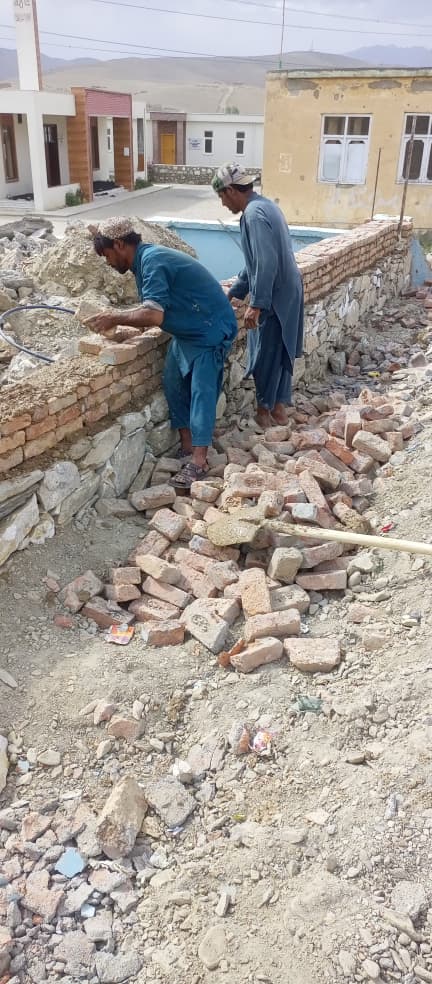 Workers continuing brick wall construction