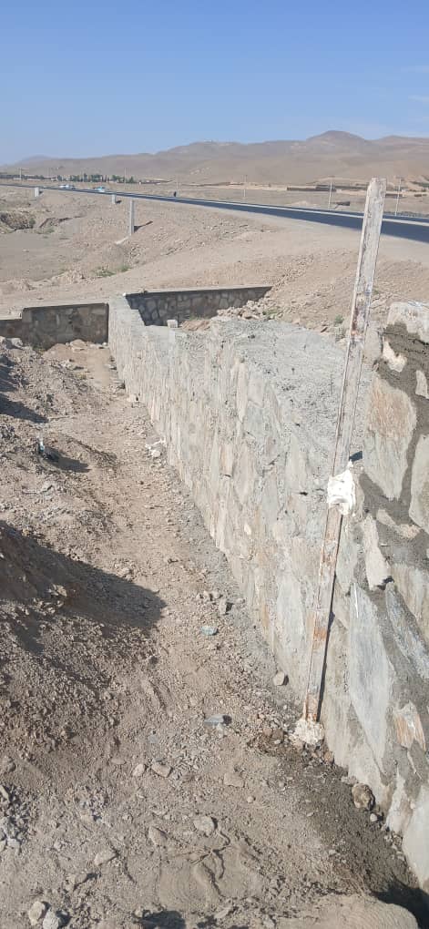Stone foundation wall built along the road at Zarni Lycee